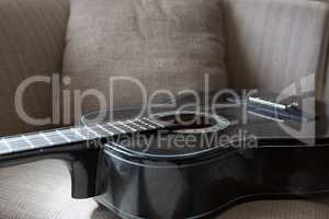 Guitar kept on sofa in living room
