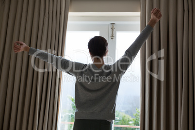 Woman stretching after wake-up in bedroom