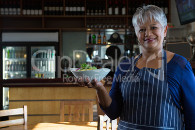 Waitress holding food bowl