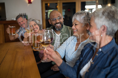 Happy friends having drinks in bar