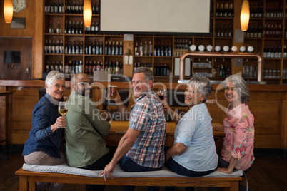 Happy friends having drinks in bar