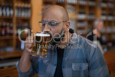 Man having glass of beer in restaurant