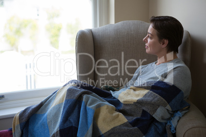 Woman relaxing on sofa in living room