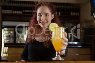 Beautiful waitress holding a drink