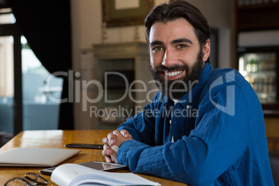 Bar tender leaning at bar counter