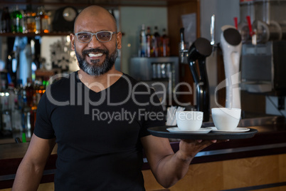 Waiter holding coffee cup