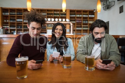 Friends using mobile phone on table