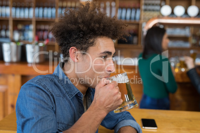 Man drinking glass of beer