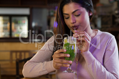 Woman sipping on a drink