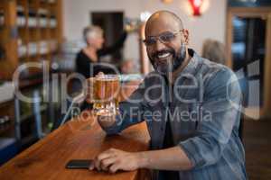Happy man having glass of beer in bar