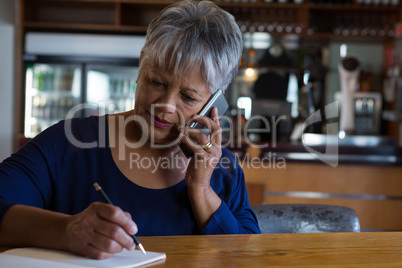 Waitress talking on his phone