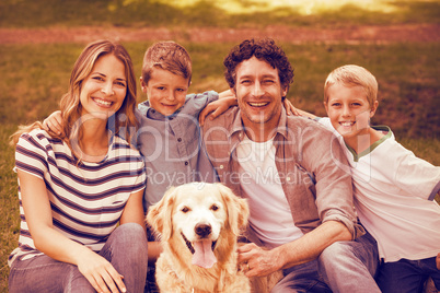 Portrait of family with dog in park