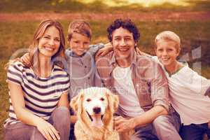 Portrait of family with dog in park
