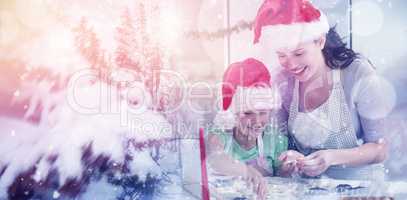 Composite image of lovely mother and daughter preparing christmas cookies