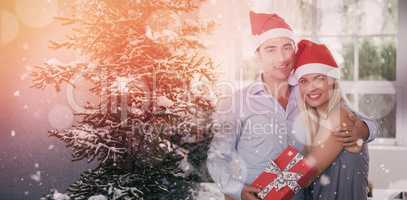 Composite image of happy couple at christmas