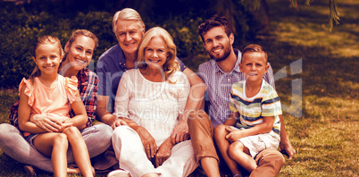 Portrait of multi generation family relaxing on grass