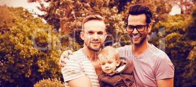 Smiling gay couple with child