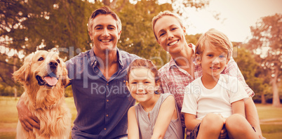 Family enjoying with dog at park