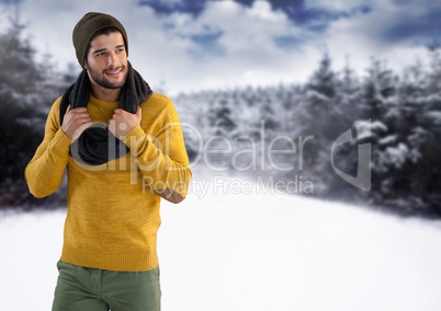 Man wearing hat and scarf in snow landscape