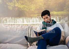 Man in Autumn reading a book by waterfall foggy imagination