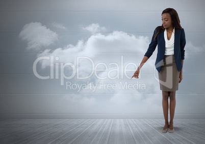 Businesswoman pointing at floor with clouds