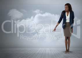 Businesswoman pointing at floor with clouds