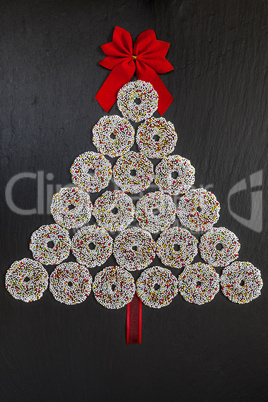 Chocolate biscuits rings with Christmas decoration on black slat