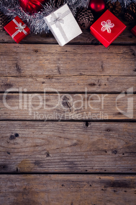 Gift boxes and christmas decorations on wooden plank