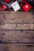 Gift boxes and christmas decorations on wooden plank