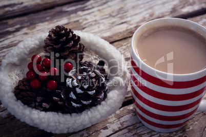 Coffee and christmas decoration on wooden plank