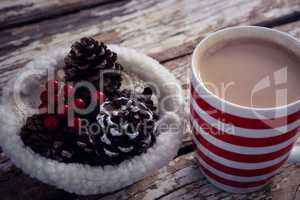 Coffee and christmas decoration on wooden plank