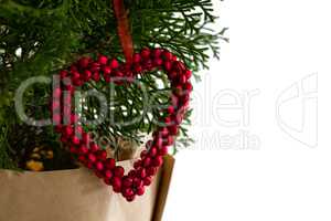 Heart shape christmas decoration hanging on christmas tree
