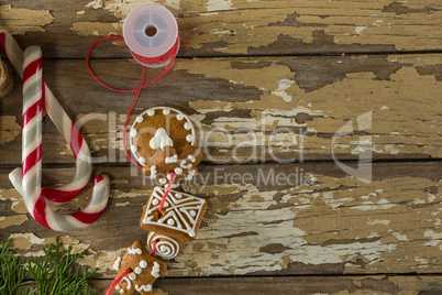 Sweet food and christmas decorations on wooden plank