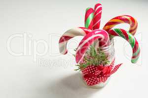 Close up of colorful candy canes in glass jar
