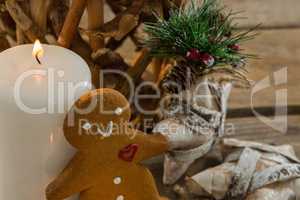 Gingerbread cookie by illuminated candle and star shape decorating