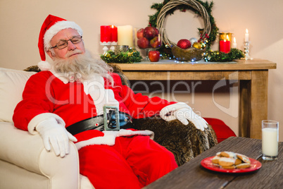 Santa claus relaxing on sofa in living room at home