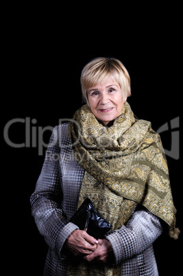 An elderly woman in a coat