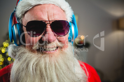Santa Claus listening to music on headphones