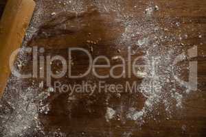 Left over flour after flattening dough on a wooden table