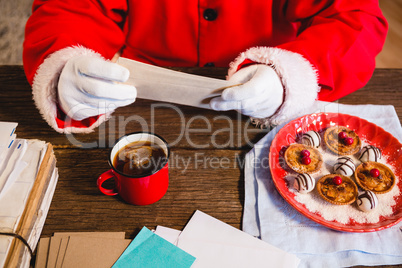Santa Claus holding a letter