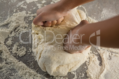 Woman kneading a dough