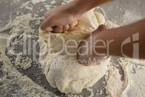 Woman kneading a dough