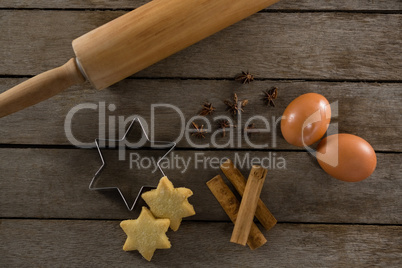 Rolling pin with eggs, cookie cutter, cookies, cinnamon and anise