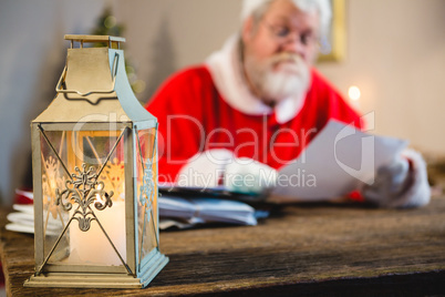 Christmas lantern and Santa Claus in background