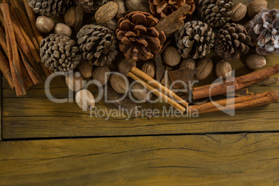 High angle view of walnuts with pine cones and cinnamon stick