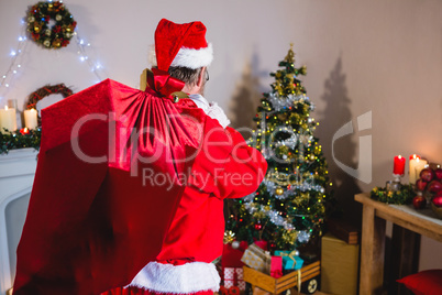 Santa Claus holding christmas bag