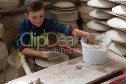 Boy making a pot