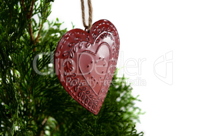 Heart shape christmas decoration hanging on christmas tree