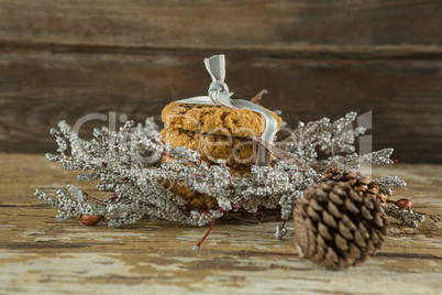 Cookies with christmas decoration arranged on wooden plank