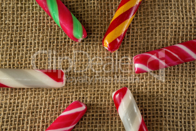 Multicolored candy canes arranged on fabric